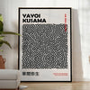 Abstract polka dot patterns in black and gray by Yayoi Kusama - in a bright minimalist room with a plant and an armchair