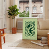 Abstract representation of yoga poses in green and gray hues - in a Parisian living room with a sofa and a fig plant
