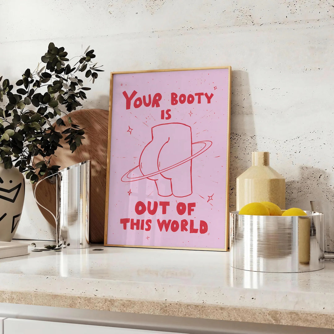 Graphic art featuring a cosmic scene with a playful depiction of a booty's silhouette - styled on a counter with eucalyptus and a bowl of lemons