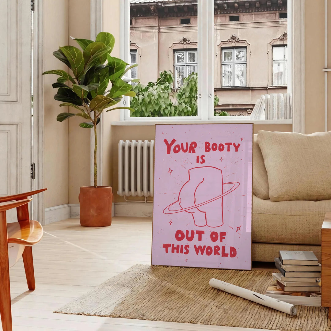 Graphic art featuring a cosmic scene with a playful depiction of a booty's silhouette - in a Parisian living room with a sofa and a fig plant