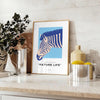 A stylized zebra in shades of blue and gray against a textured background - styled on a counter with eucalyptus and a bowl of lemons