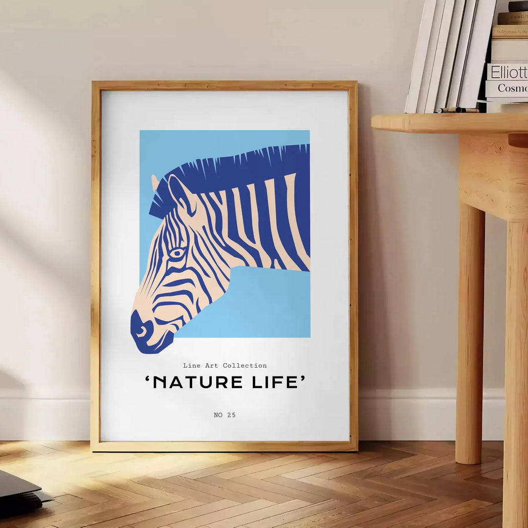 A stylized zebra in shades of blue and gray against a textured background - beside a round wooden side table with books
