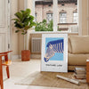 A stylized zebra in shades of blue and gray against a textured background - in a Parisian living room with a sofa and a fig plant