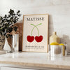 Red and orange paper-cut cherries in a mid-century style