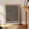 Minimalist poster featuring black lines on a gray background, inspired by Bauhaus design