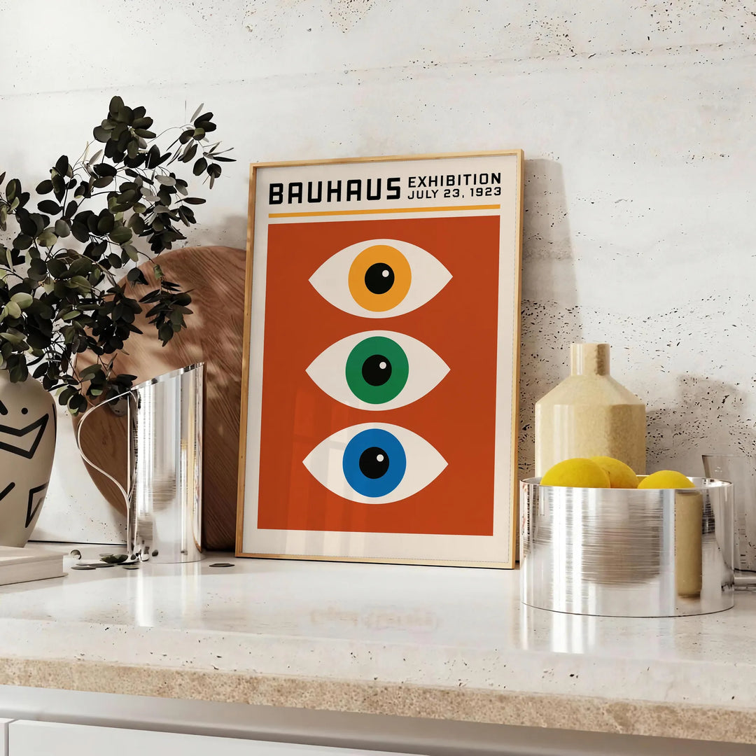 Bauhaus poster featuring stylized eyes in bold orange and green