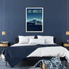 A colorful illustration of the Los Angeles skyline with palm trees - in a black frame