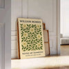 Intricate floral pattern in gray and orange by William Morris