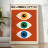 Bauhaus poster featuring stylized eyes in bold orange and green