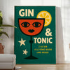 A gin and tonic cocktail with orange zest and green garnishes