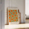 William Morris botanical design featuring intricate floral patterns in orange and green