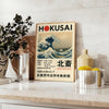 Hokusai exhibition poster featuring waves and red accents
